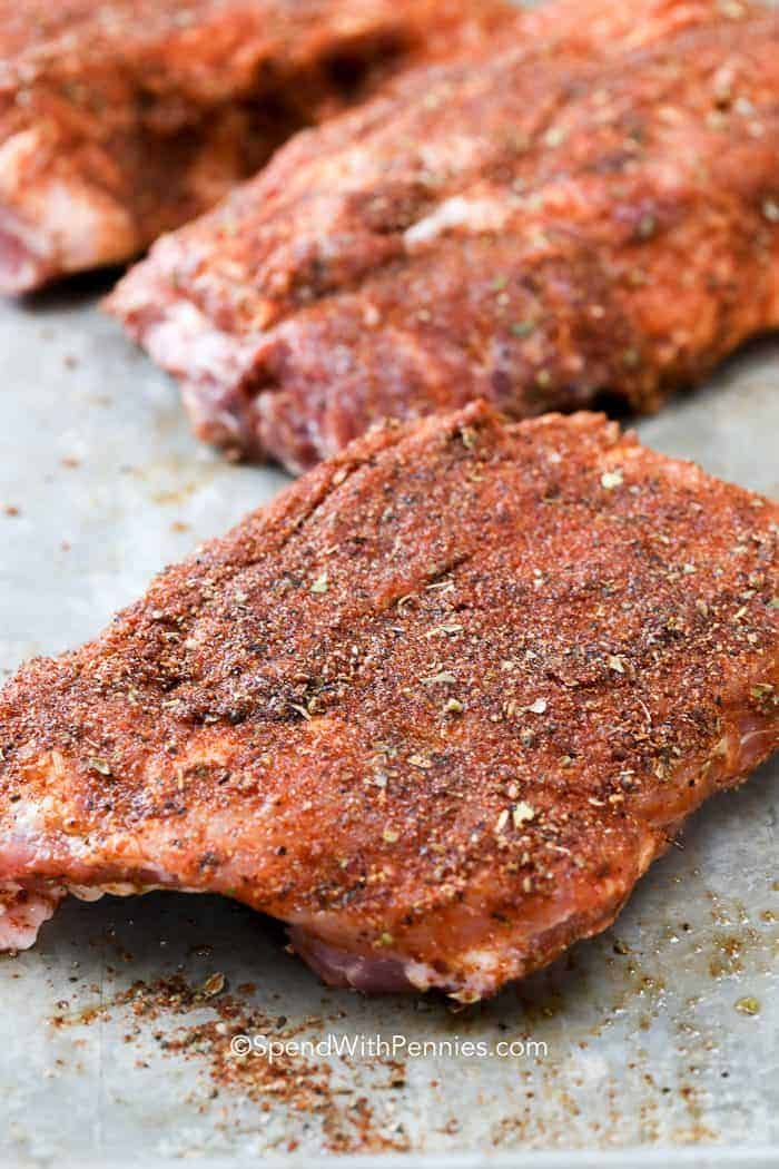 Tender oven baked ribs are the perfect meal any time of year. Seasoned and cooked low and slow, these ribs are going to become a go-to for melt-in-your-mouth goodness all year round. Brushed generously in your favorite BBQ sauce and sealed with a quick grill, these ribs are finger-licking good! #spendwithpennies #ovenbaked #barbecueribs #grilling Barbecue Ribs before being cooked in the oven