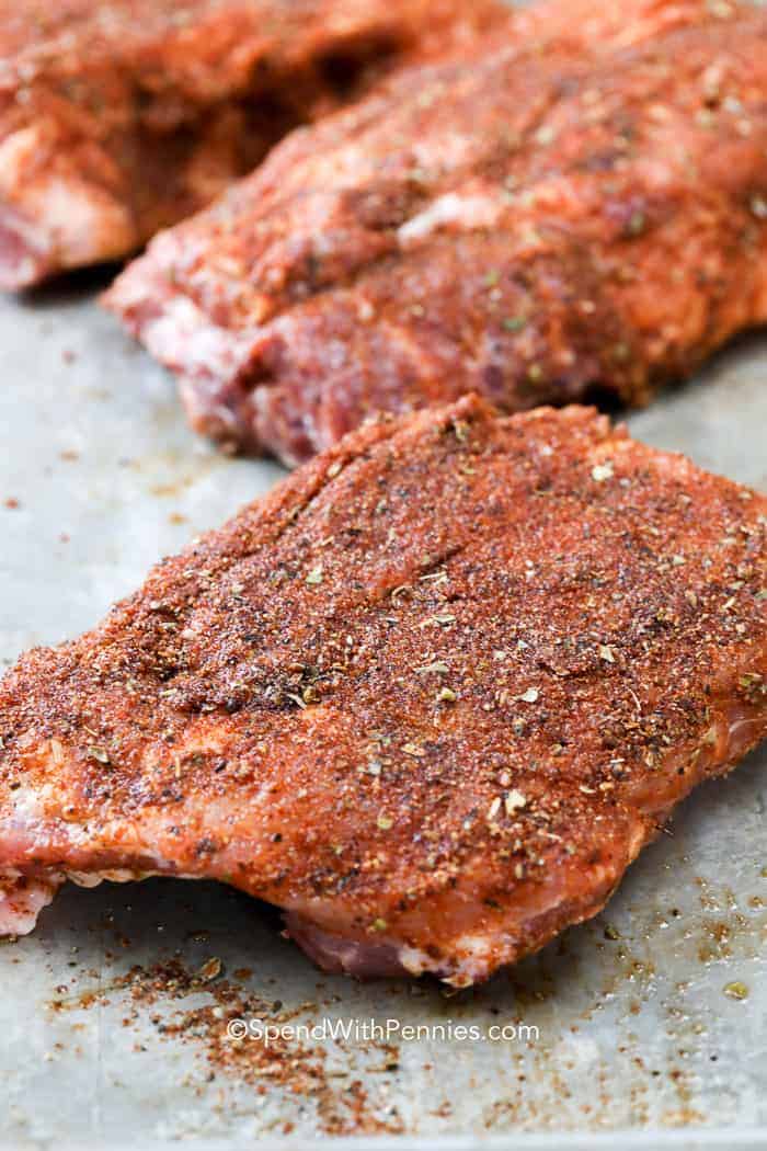Oven baked ribs come out melt in your mouth tender and so flavorful. Seasoned and cooked low and slow, these tender ribs are sealed off with a flash grill and some BBQ sauce! Serve with a side of beans or fresh salad for the perfect meal any time of the year. #ovenbakedribs #ribs #recipe #spendwithpennies Barbecue Ribs before being cooked in the oven