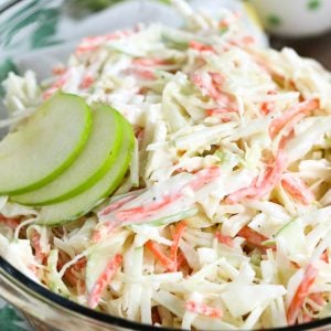 Clear bowl of Creamy Apple Slaw with slices of apples