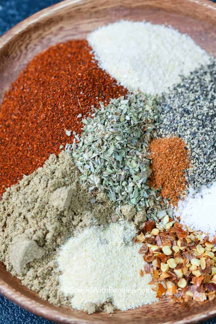 Ingredients for Homemade Taco Seasoning on a wooden plate