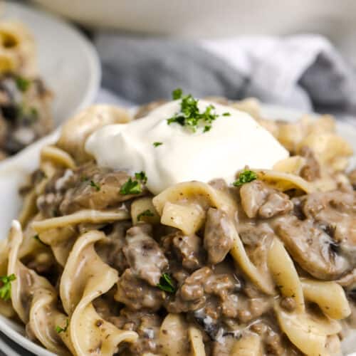 A plate of mushroom stroganoff topped with sour cream