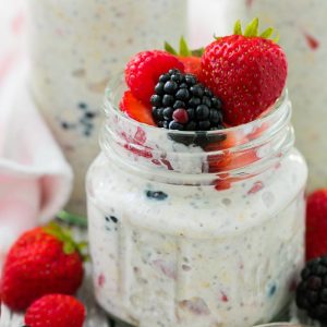 Refrigerator Oatmeal in a glass jar with berries on top