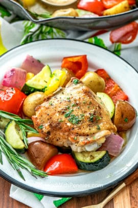 Roasted Rosemary Chicken and vegetables served on a white plate
