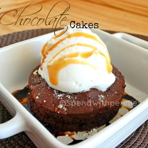 individual fudge chocolate cake topped with ice cream in a white dish