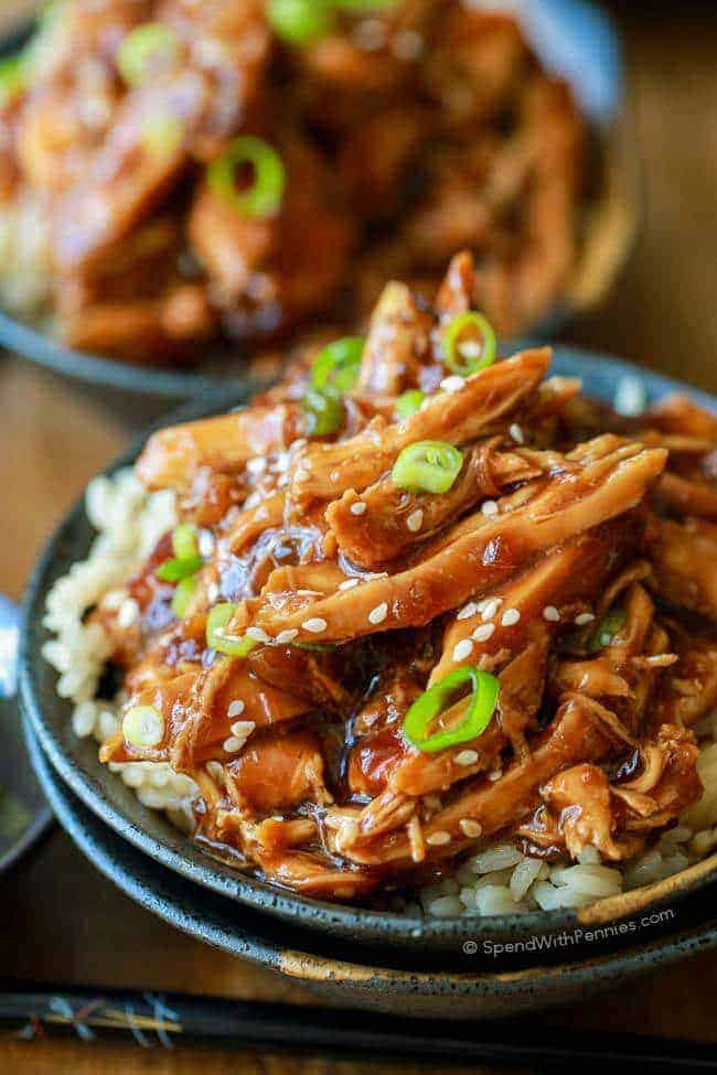 Slow Cooker Honey Garlic Chicken served over rice in a bowl