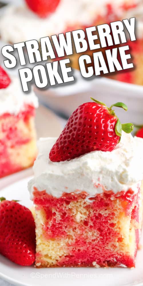 A slice of strawberry poke cake topped with a strawberry with writing