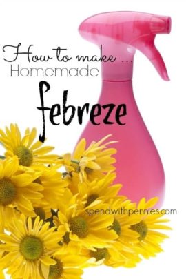 a pink spray bottle of homemade febreeze with flowers around it