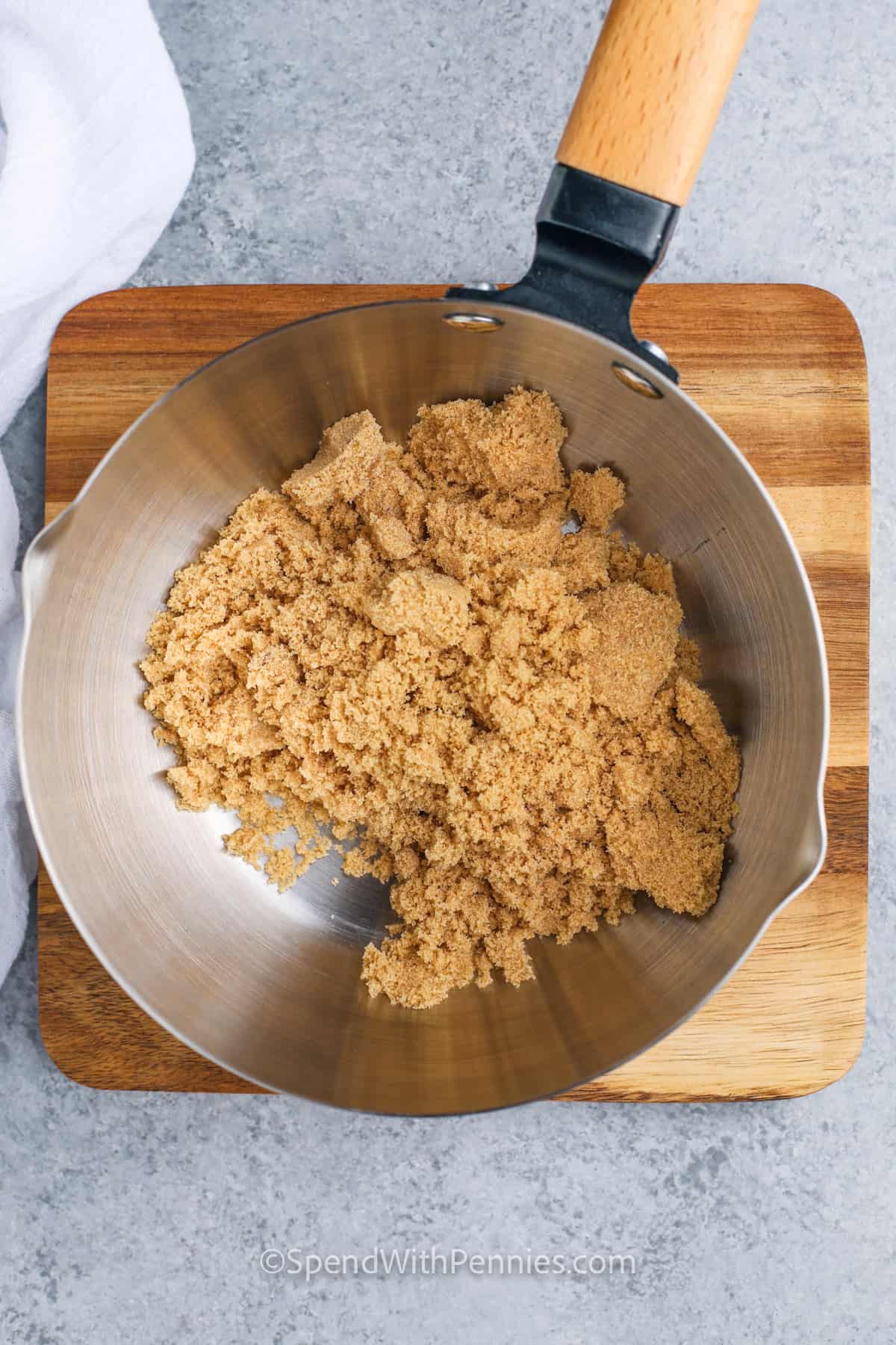 Add brown sugar to a saucepan to make a hot fudge sauce recipe