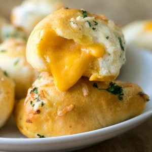 Garlic Cheddar Biscuit with cheese oozing out of it