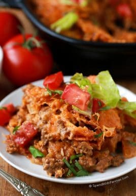 Layered Doritos Casserole is an easy family favorite recipe! Lean ground beef is seasoned with taco seasoning and salsa to create a delicious filling. Layers of Doritos create a delicious base for this casserole which is then topped with cheese and baked until brown and bubbly. We top it with our favorite taco inspired toppings!