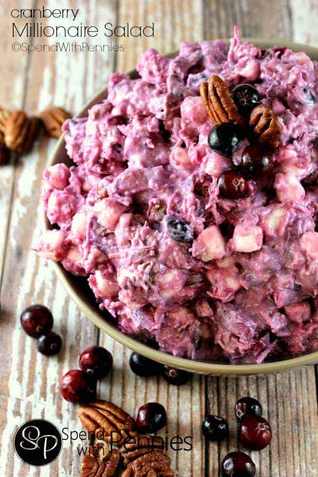 Cranberry Millionaire Salad in a bowl topped with. pecans and cranberries