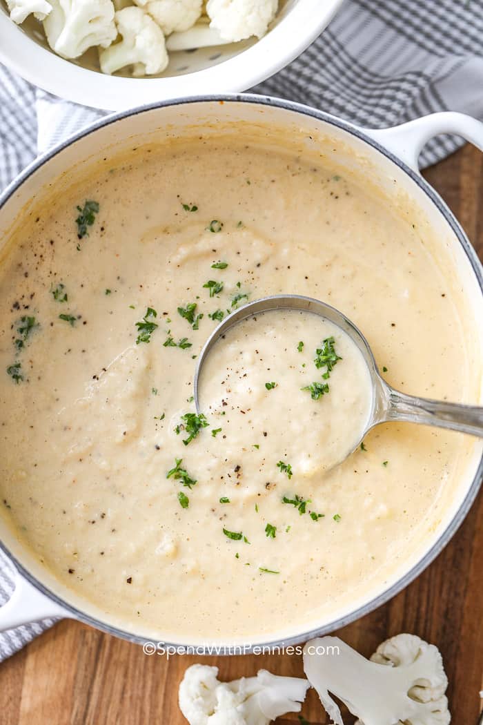 Overhead picture of Creamy Cauliflower Soup in a pot with a ladle