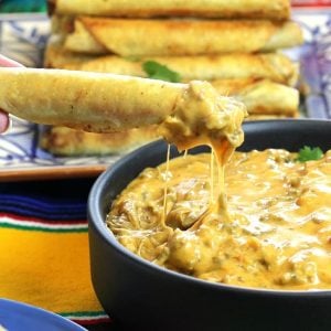 Cheesy Taquito Beef Queso Dip served in a black dish