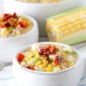 Ham and corn chowder with bacon in white bowls