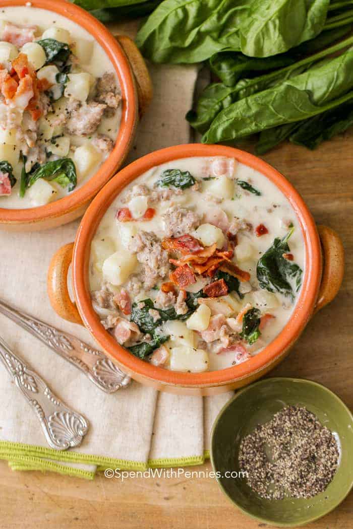 Zuppa Toscana is a hearty Italian soup recipe has potatoes, sausage and bacon in a light, creamy broth. It is so delicious! #spendwithpennies #zuppatoscana #easysoup #creamysoup #withspinach #withpotatoes #withbacon #heartysoup two bowls of Zuppa Toscana ready to eat