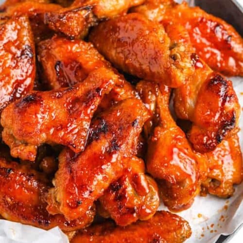 a plate of stacked hot sticky wings