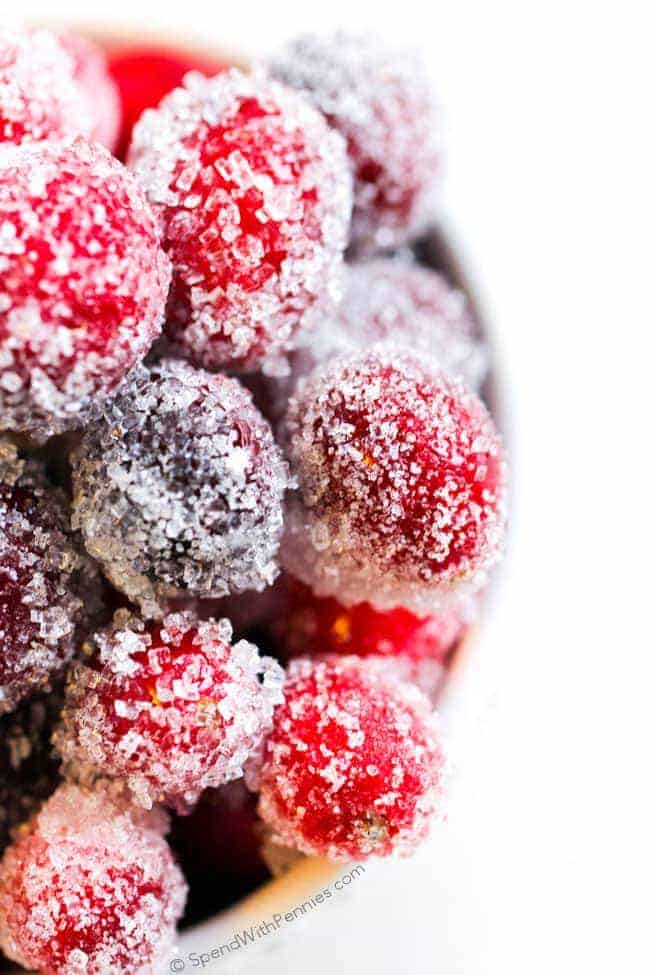 close up of sugared cranberries in a white bowl