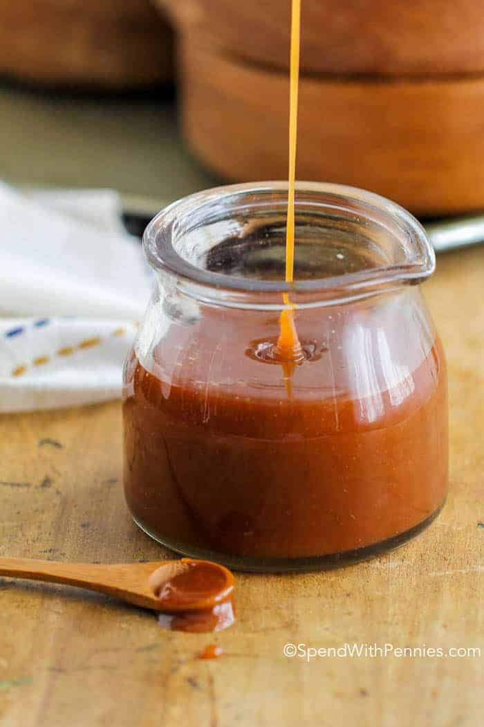 Pouring Homemade Caramel Sauce into a glass jar