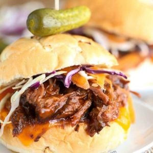 Slow Cooker BBQ Beef Sandwiches with a pickle on top