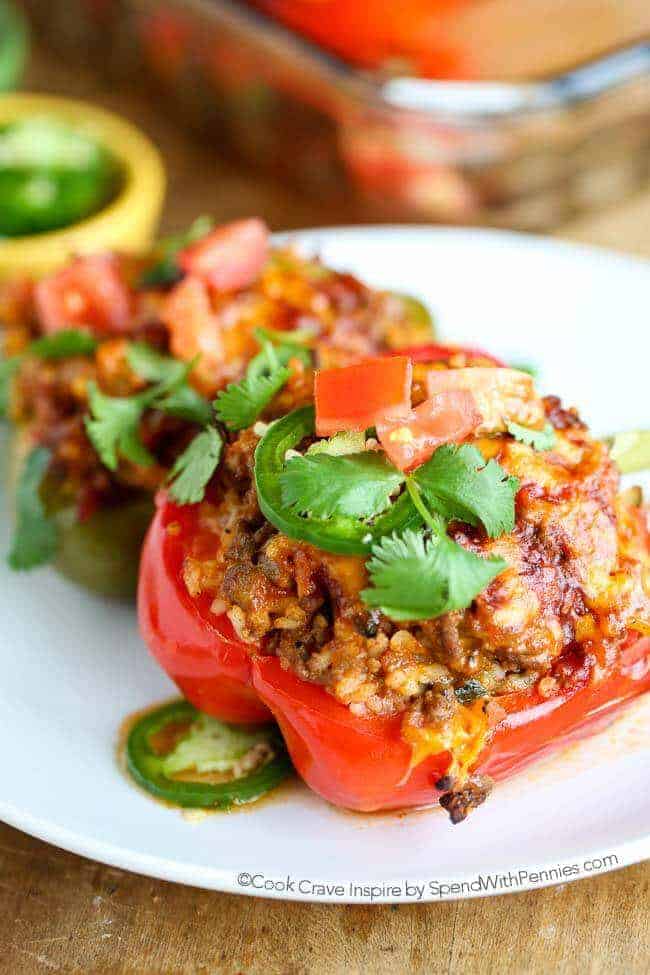 Mexican Stuffed Peppers make for an incredible dinner any night of the week. They are filling, absolutely delicious and they can be prepared ahead of time. This recipe puts a scrumptious southwestern spin on a classic recipe creating a new family favorite! Substitute Cauliflower Rice for a low carb, low cal option!