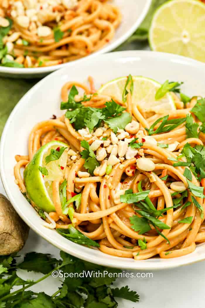 Peanut Thai noodles in a bowl with peanuts and cilantro on top