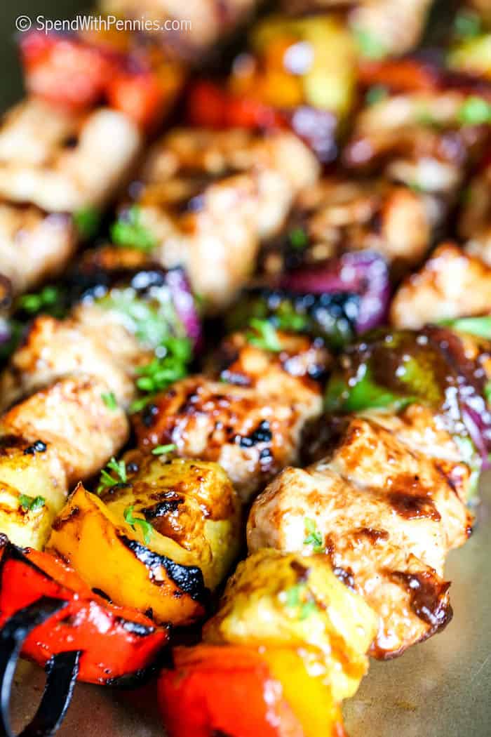 Serve these Hawaiian chicken kabobs as a flavorful main dish for dinner tonight. The sight of these colorful chicken kabobs skewers will make any mouth water. Juicy morsels of chicken, an assortment of colorful vegetables, and sweet pieces of pineapple are marinated and then cooked to perfection on the BBQ. So delish and oh so good! #hawaiianchickenkabobs #chickenkabobs #chickenkabob #spendwithpennies Hawaiian Kabobs closeup