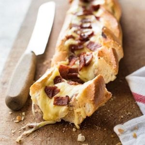 Pizza Dip Stuffed Baguette on a cutting board