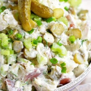 Bowl of Dill Pickle Potato Salad with two small pickles on top