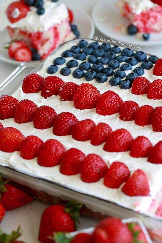 Flag cake in a clear baking dish with two slices in the background