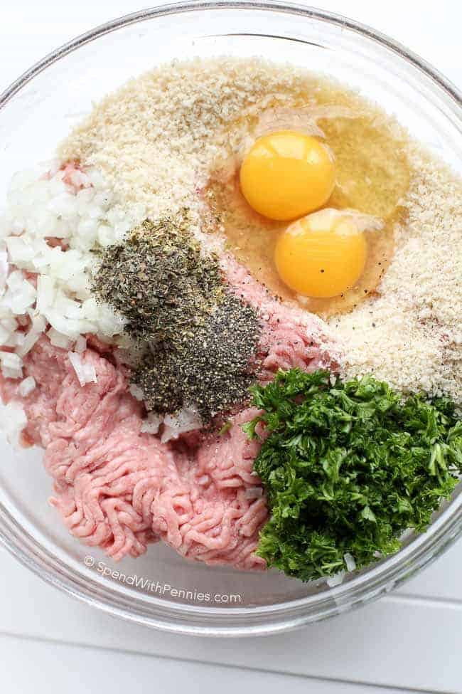 All-purpose turkey meatballs are a versatile and wholesome choice. With lean turkey meat as their base, they provide a tasty and nutritious protein option. From pasta dishes to sandwiches and appetizers, these turkey meatballs are a delightful addition to any meal. #turkeymeatballs #allpurpose #meatballs #spendwithpennies Clear glass bowl of turkey meatball ingredients before being mixed together