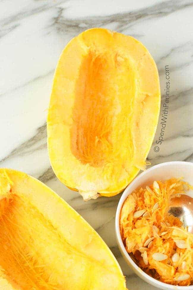 Spaghetti Squash cut and the seeds scraped into a bowl