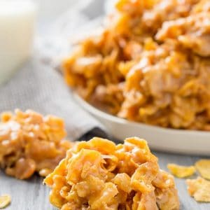 No bake peanut butter cornflake cookies on a wood table with milk