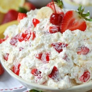 bowl of Strawberry Banana Salad with a strawberry and a banana on top