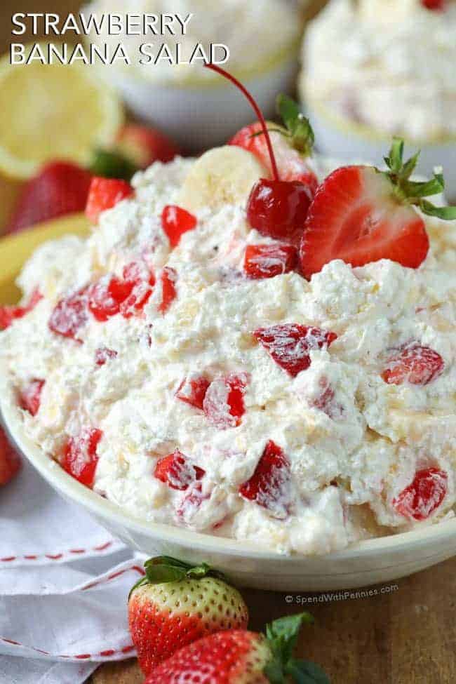 bowl of Strawberry Banana Salad with a strawberry and a banana on top