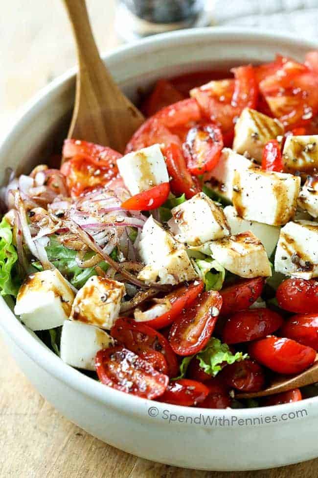 mixing up Tomato Mozzarella Salad