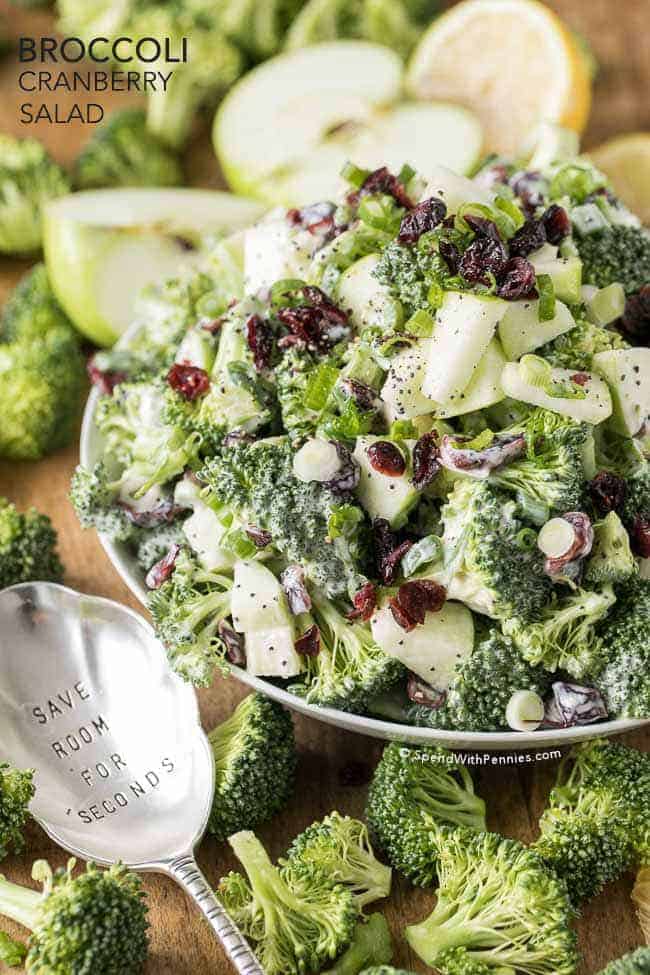 Broccoli Cranberry Salad in a white bowl with a spoon and text