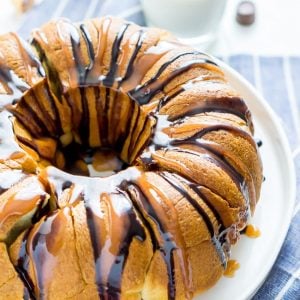Rolo pull apart bread on a white plate with milk in the background