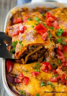 This beef enchilada casserole is layers of ground beef, beans, tortillas and cheese, all smothered in enchilada sauce and baked to perfection. A super easy dinner that's sure to be a crowd pleaser!
