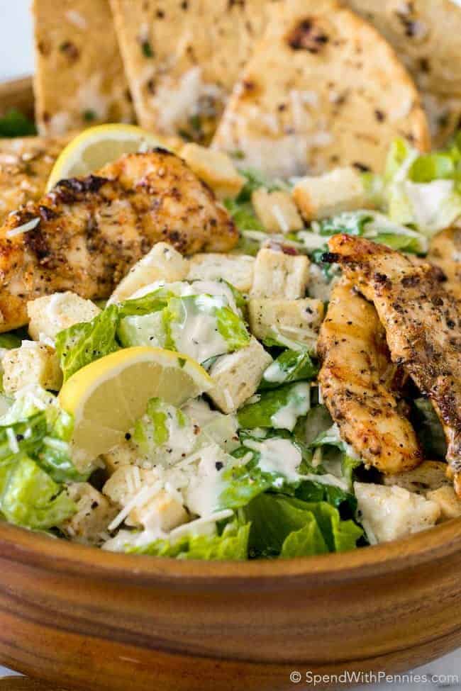 Chicken Caesar Salad with Grilled Flatbread is the perfect summer meal! Juicy chicken, crisp fresh lettuce with a creamy garlic parmesan dressing all topped off with a grilled garlic parmesan flatbread.