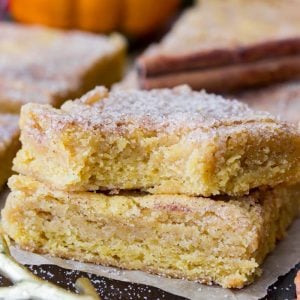 Two stacked Pumpkin Blondies, one with a bite taken out of it.