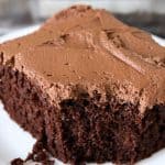 Piece of Chocolate Mayonnaise Cake on a white plate with a bite taken out of it