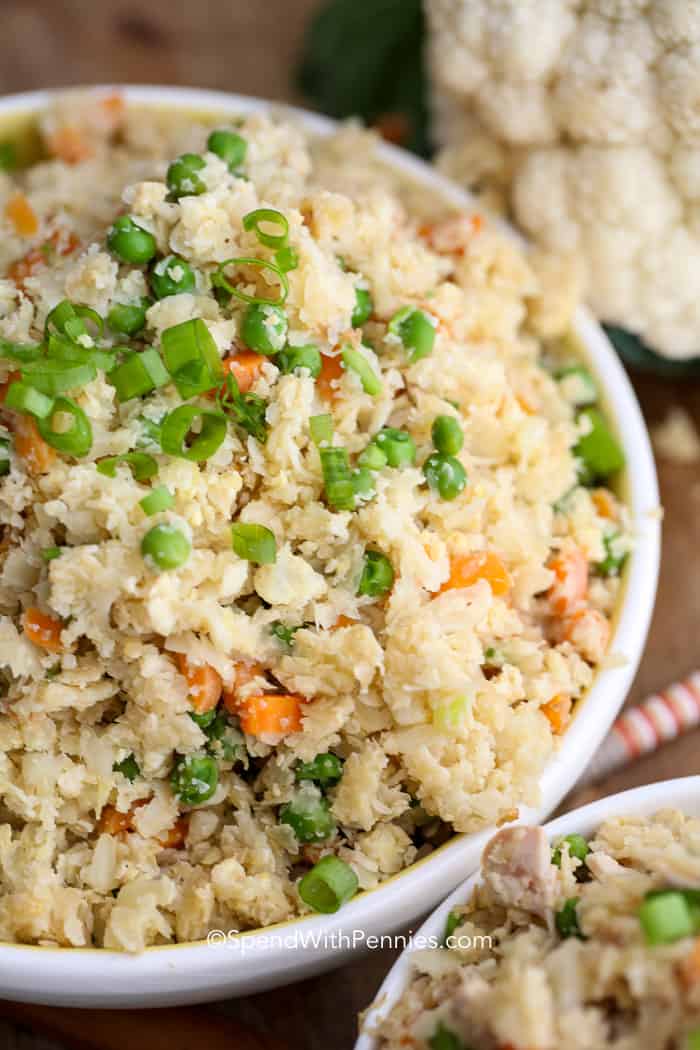 White bowl of Cauliflower Fried Rice with green onions