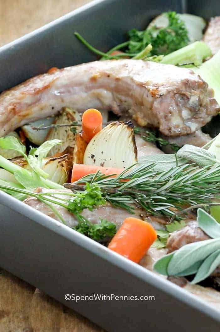 Chicken, veggies and herbs in a pan for How to Make Chicken Stock