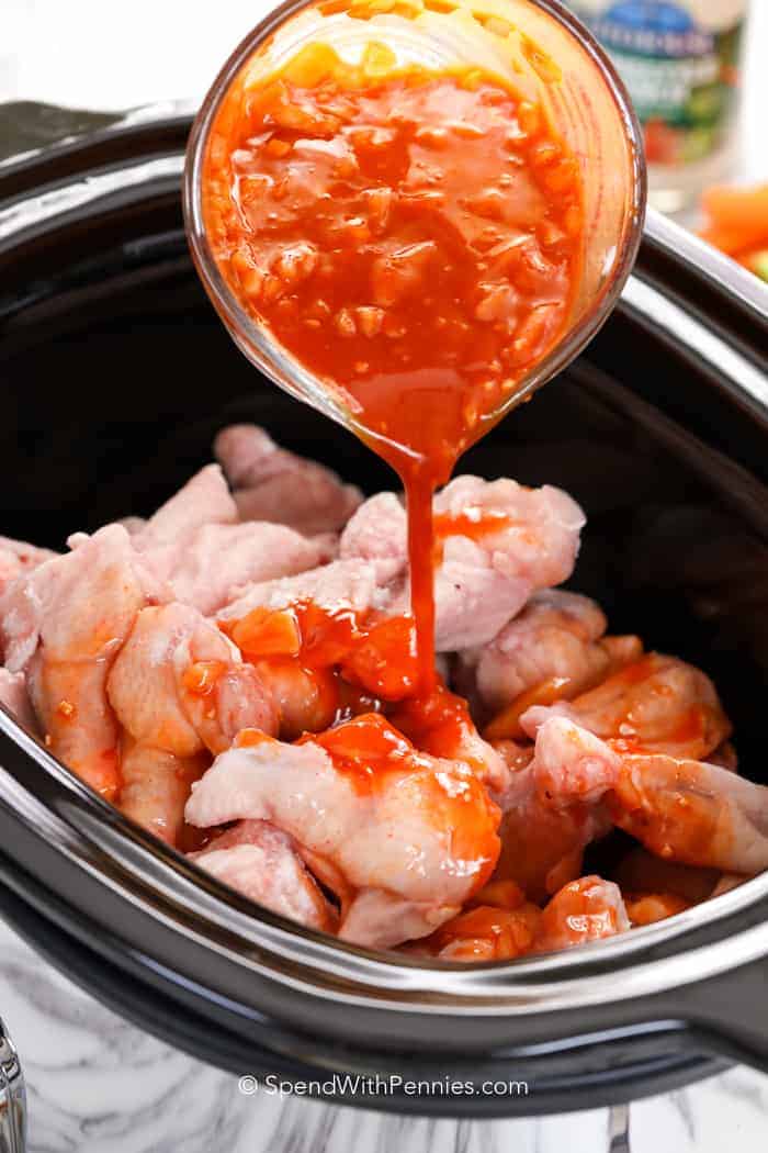 Raw chicken wings and sauce for Crock Pot Chicken Wings