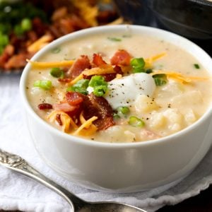 White bowl with Baked Potato Soup and a spoon