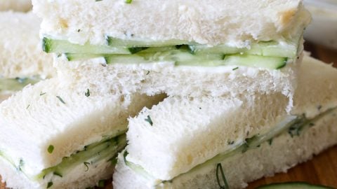 Cucumber Sandwich pieces on a wooden board