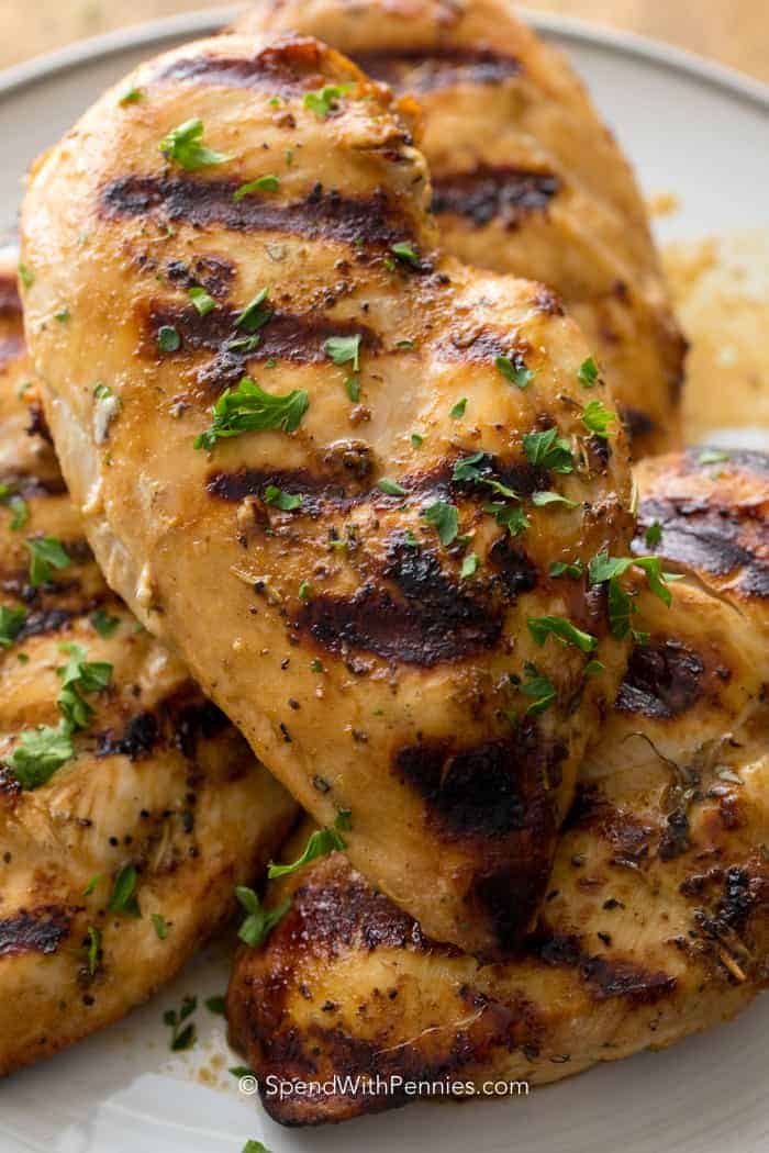 Easy Grilled Chicken Breast is a delicious marinated chicken recipe resulting in the most flavorful and tender chicken ever to come off your grill! Make this in advance for a quick weeknight meal! Serve with roasted potatoes, corn on the cob, and a fresh salad for a family dinner or a backyard BBQ! #grilledchickenbreast #recipe #grilledchicken #spendwithpennies Easy Grilled Chicken Breast