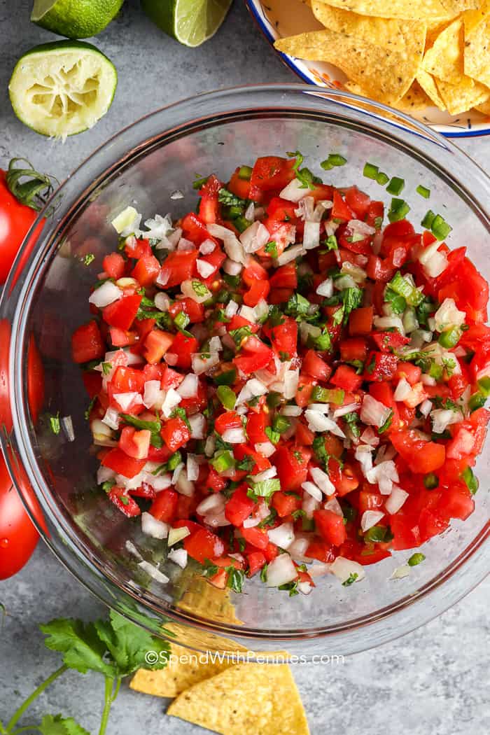 Pico de Gallo in a bowl with chips and ingredients