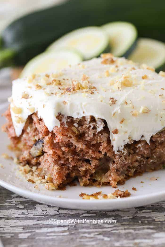 Zucchini Cake on a white plate with bite taken out of it