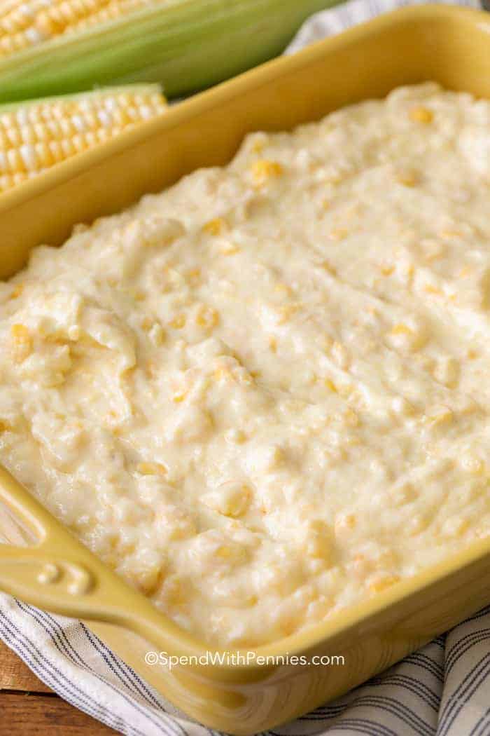 Whipping up corn casserole, a beloved Southern comfort dish, is a breeze. Combine Jiffy Corn Muffin Mix, fresh (or frozen) corn, and creamed corn for a golden, moist, and buttery outcome every time! Ideal as a holiday side, plus you can prep it in advance! #corncasserole #thanksgiving #christmas #spendwithpennies Corn Casserole in yellow baking dish before cooking